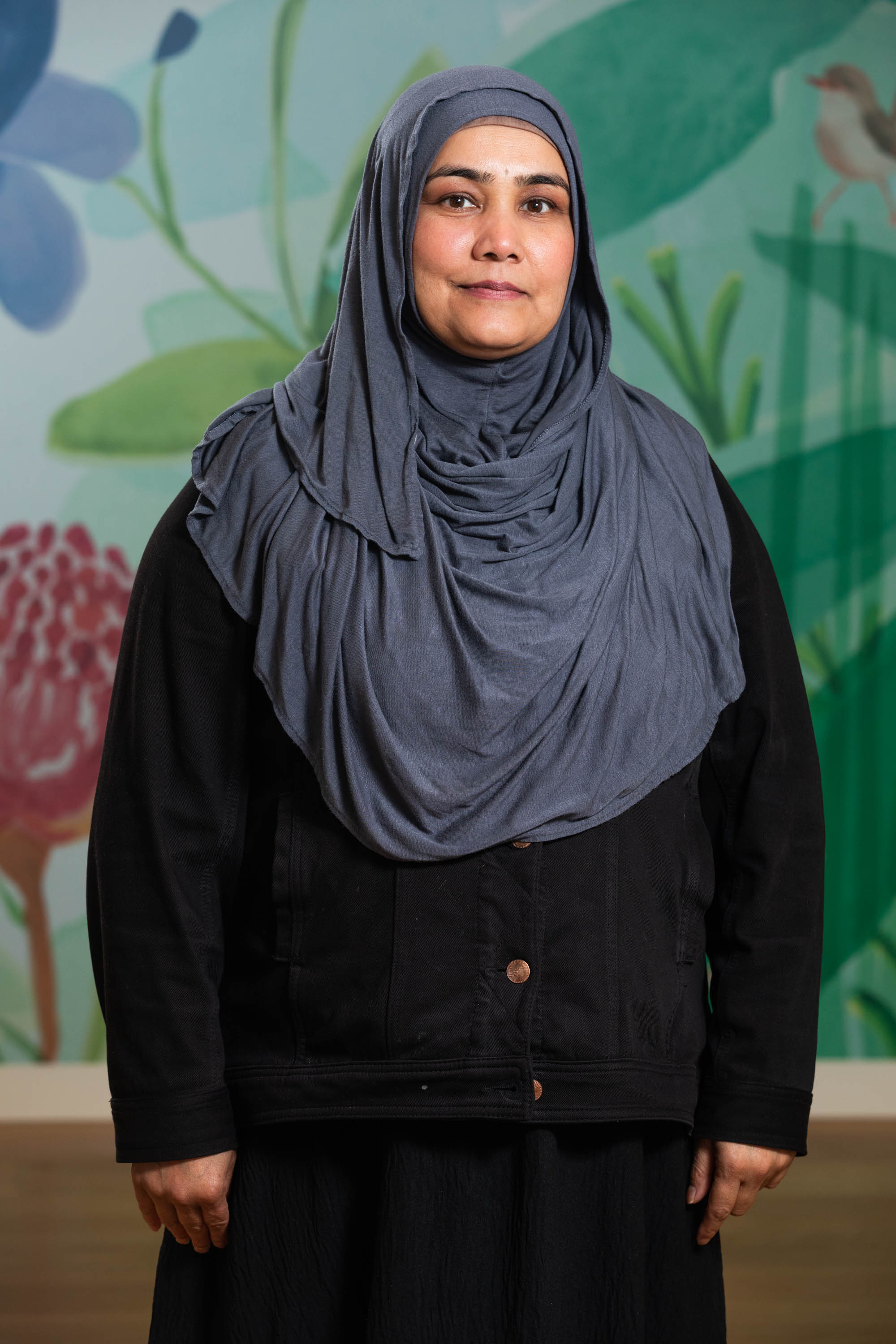 A person wearing a black hijab and suit