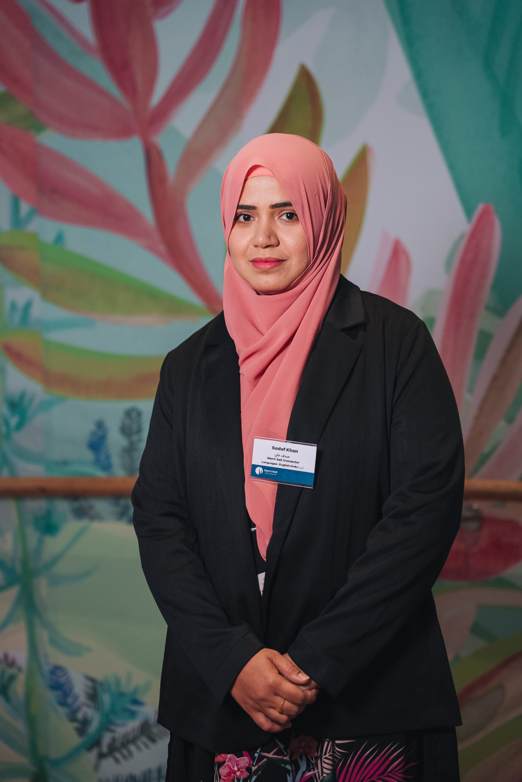 A person wearing hijab and black suit