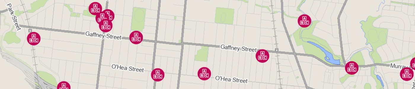 A street map in beige and green with red circles that represent kindergartens