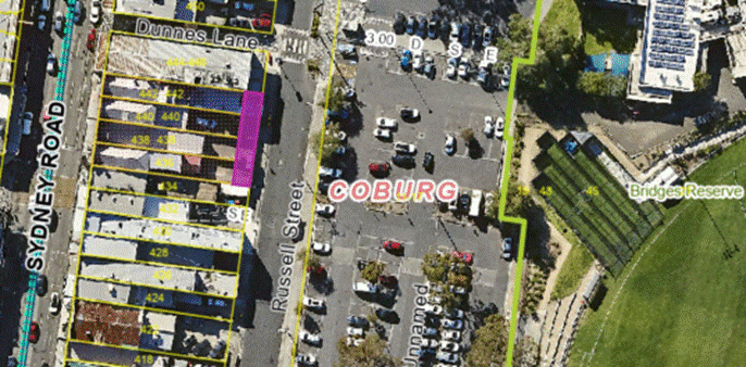 An aerial photograph of Coburg showing Sydney Road at the left and Bridges Reserve to the right with a bright magenta rectangle along the rear of 4 properties that front Sydney road. An aerial photograph of Coburg showing Sydney Road at the left and Bridges Reserve to the right with a bright magenta rectangle along the rear of 4 properties that front Sydney road.